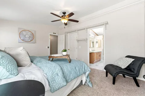 a bedroom with a bed and a chandelier