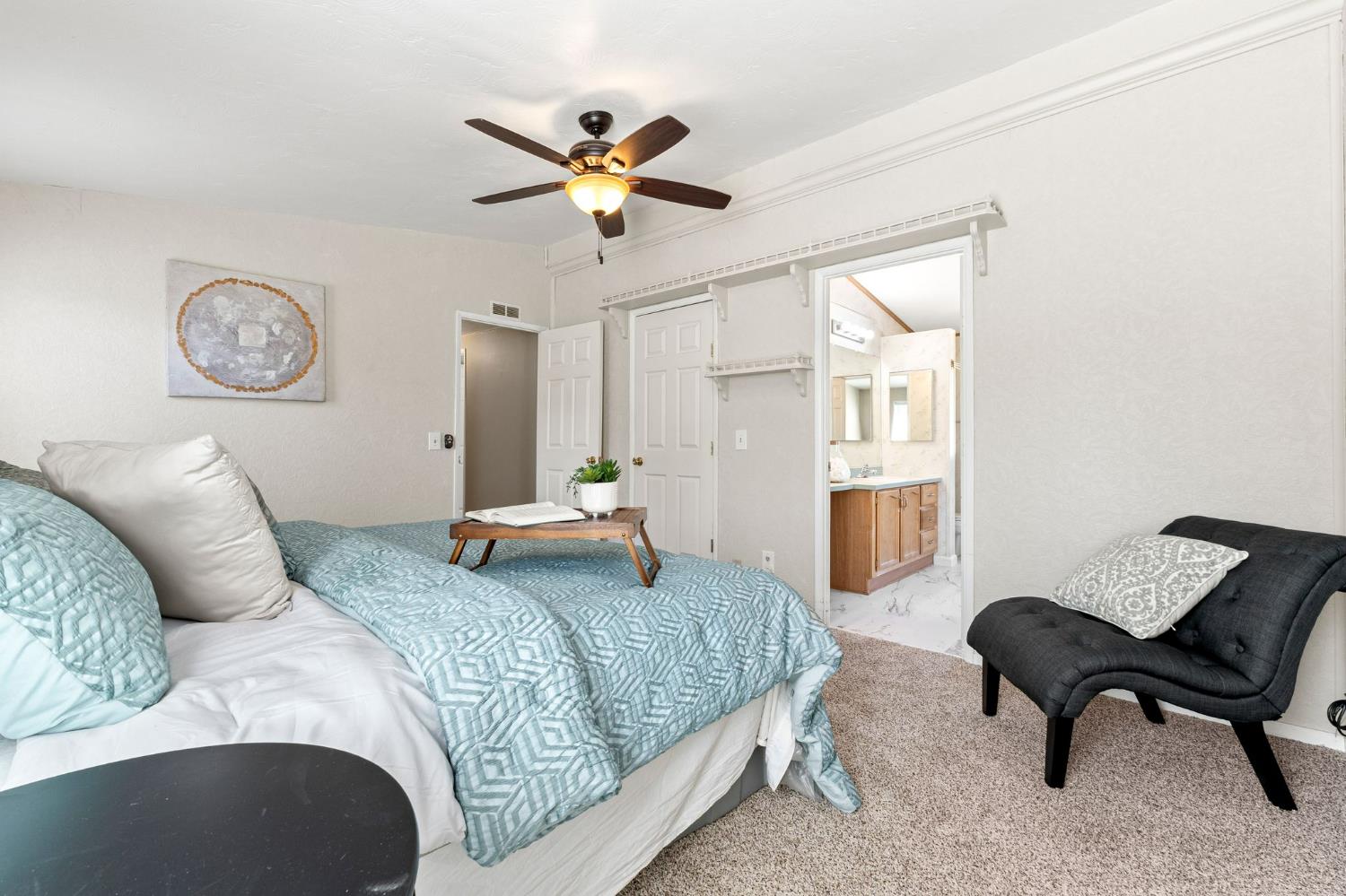 4390 Patterson Drive, Unit 218 Diamond Springs, CA 95619 - Photo 19 of 45 a bedroom with a bed and a chandelier