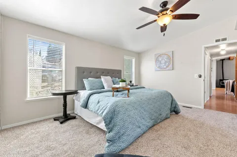 a bedroom with a bed and a chandelier