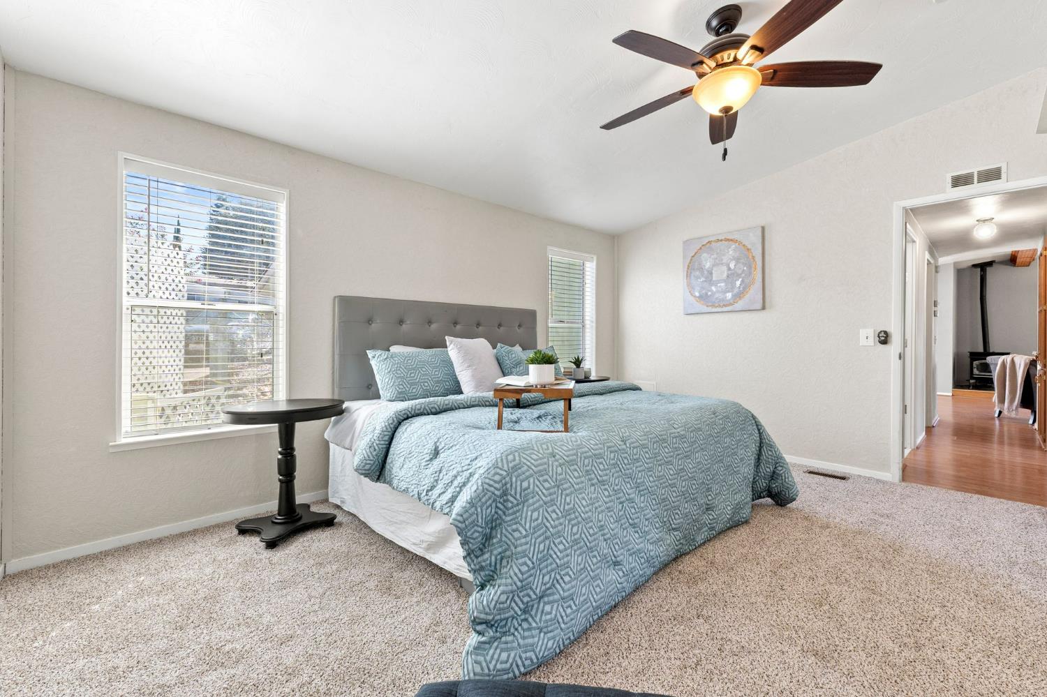 4390 Patterson Drive, Unit 218 Diamond Springs, CA 95619 - Photo 20 of 45 a bedroom with a bed and a chandelier