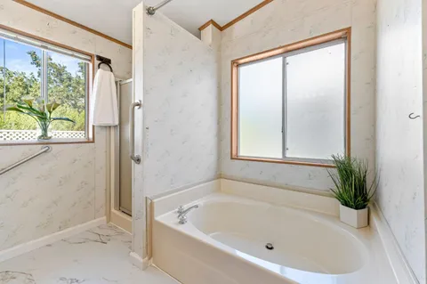 a white bath tub sitting next to a window