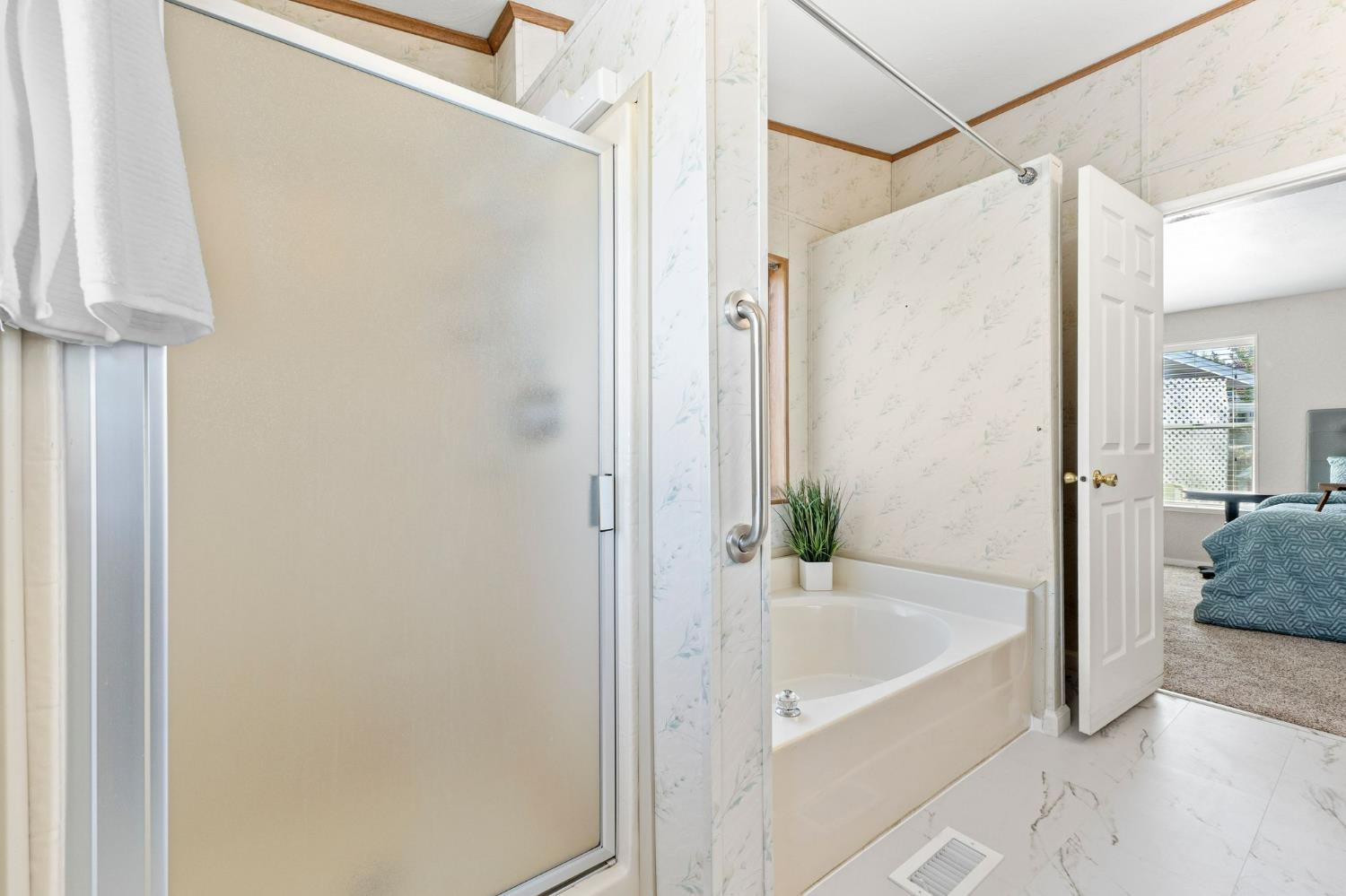 4390 Patterson Drive, Unit 218 Diamond Springs, CA 95619 - Photo 23 of 45 a bathroom with a bathtub and a shower