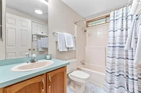 a bathroom with a sink toilet a shower and a mirror