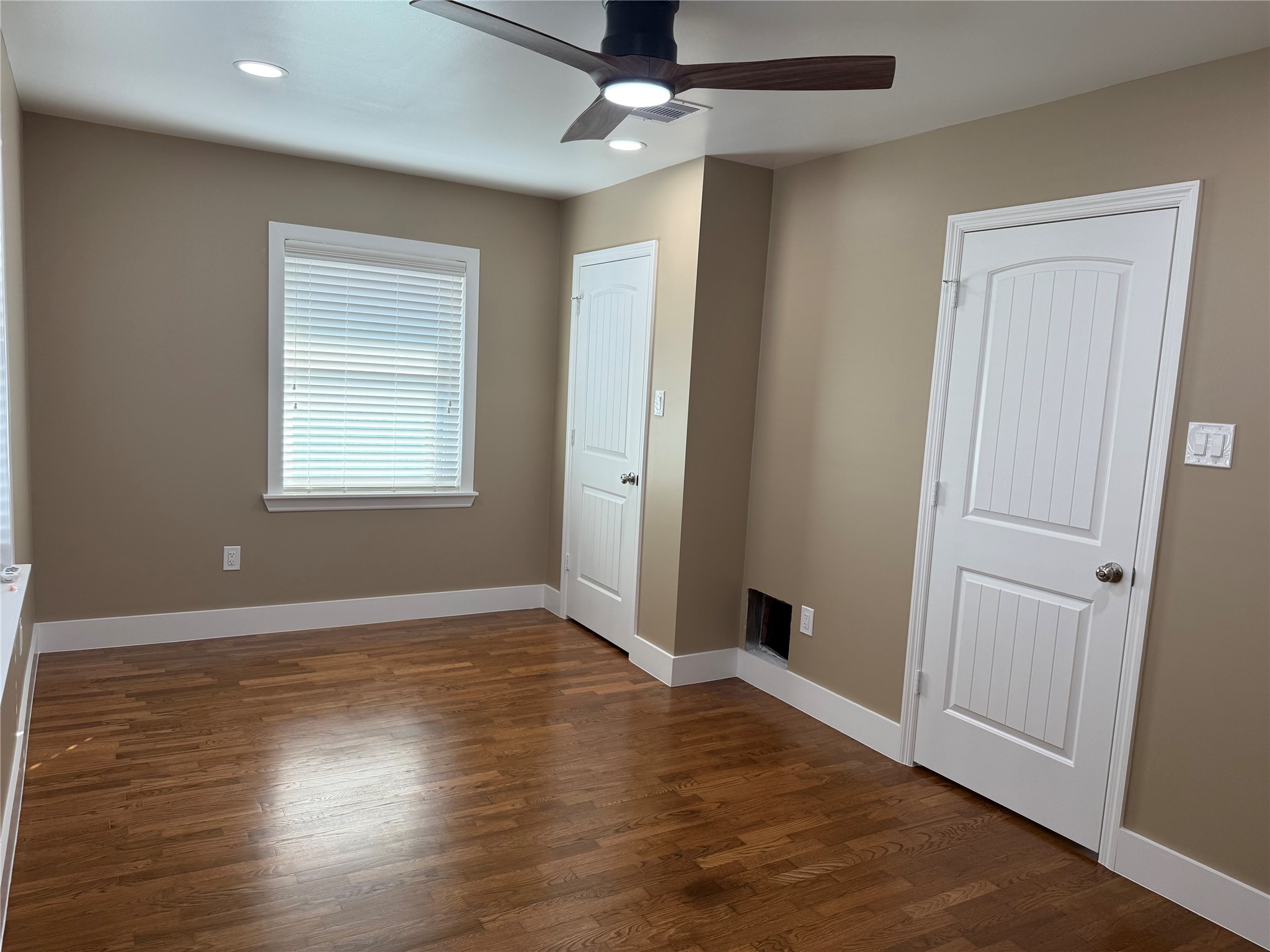 4127 Colgate Street Houston, TX 77087 - Photo 16 of 16 an empty room with wooden floor chandelier fan and windows