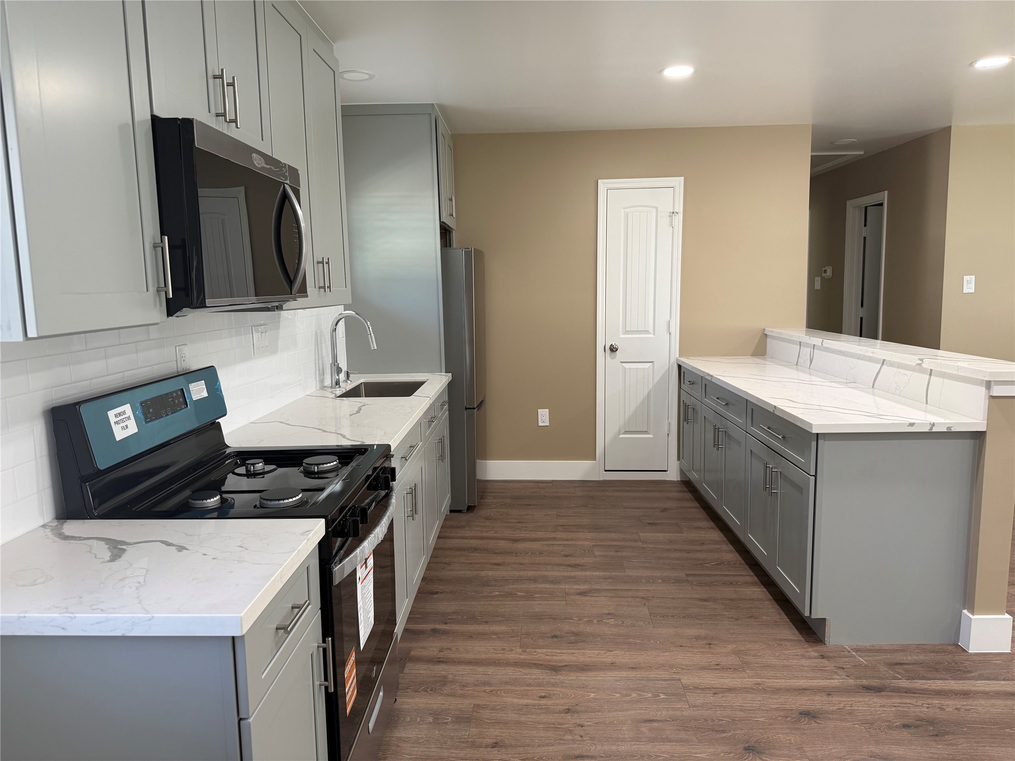 4127 Colgate Street Houston, TX 77087 - Photo 6 of 16 a kitchen with a sink stove and refrigerator
