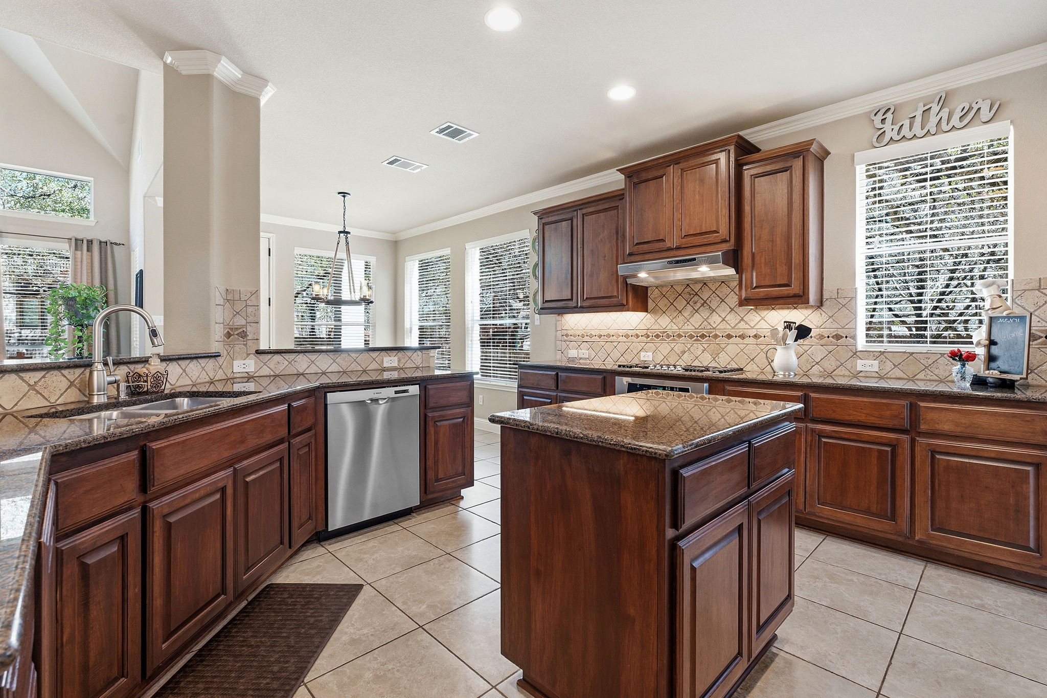 2807 Rambler Valley Drive Cedar Park, TX 78613 - Photo 6 of 38 a kitchen with kitchen island granite countertop a sink stove and cabinets