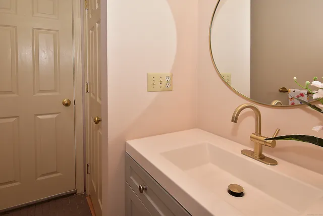 a bathroom with a sink and vanity