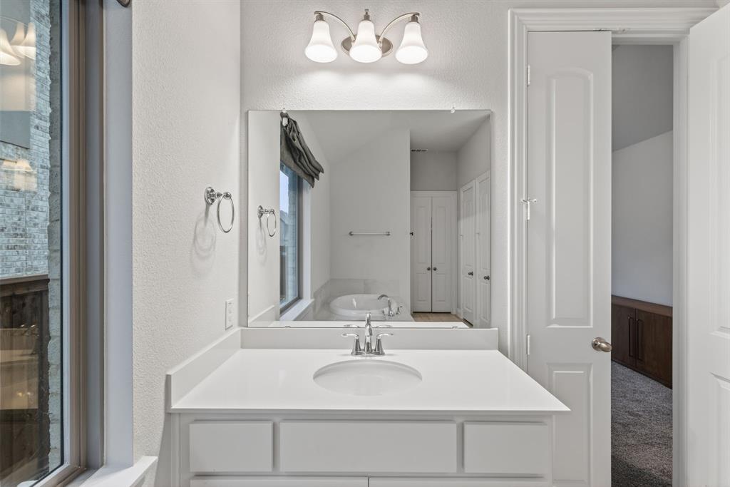 4150 Gambel Road Prosper, TX 75078 - Photo 23 of 39 Bathroom with a garden tub and a textured wall