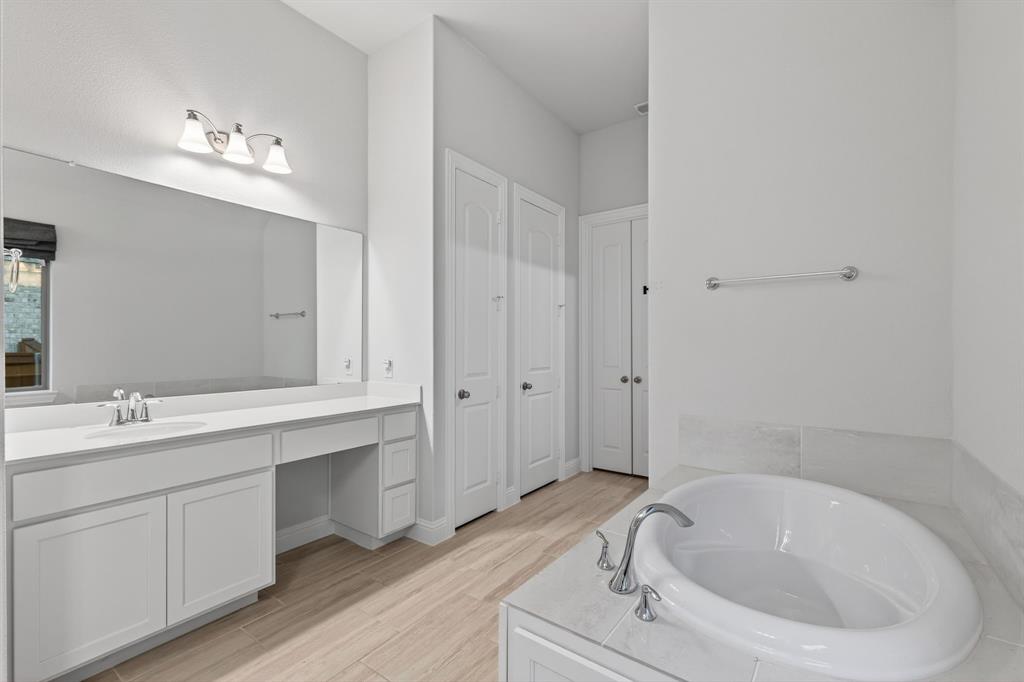4150 Gambel Road Prosper, TX 75078 - Photo 25 of 39 Full bath with a bath, vanity, light wood finished floors, and a closet