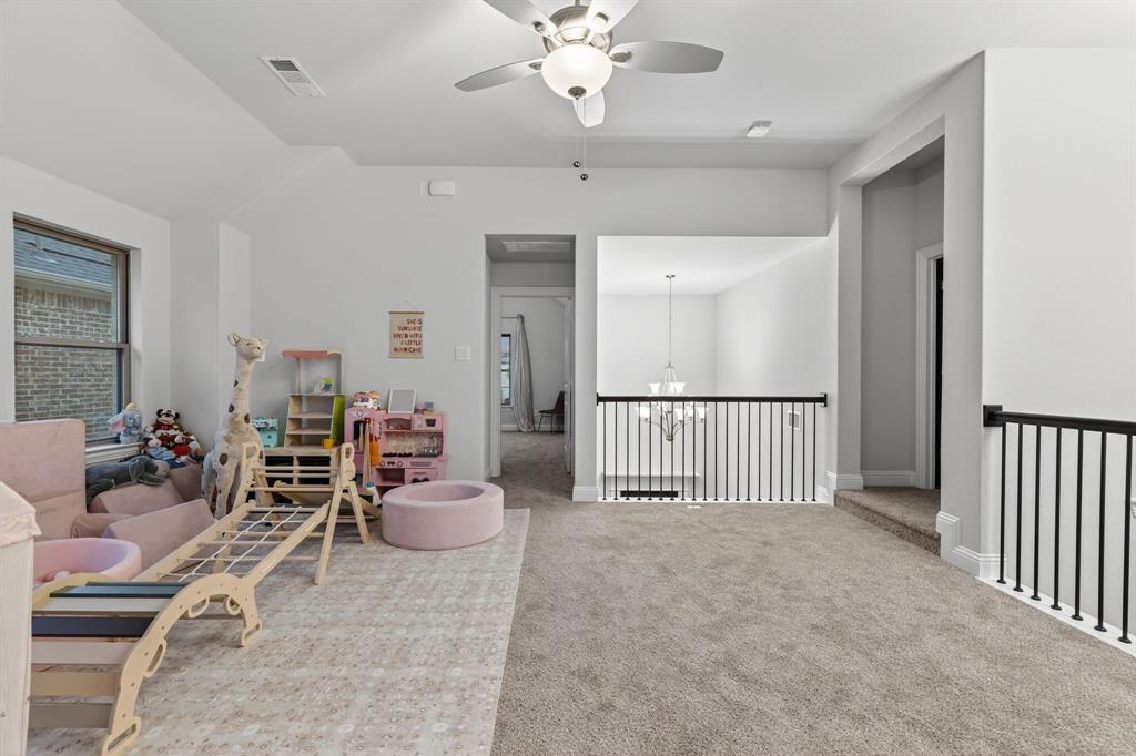 4150 Gambel Road Prosper, TX 75078 - Photo 29 of 39 Sitting room featuring ceiling fan, carpet floors, a chandelier, and vaulted ceiling