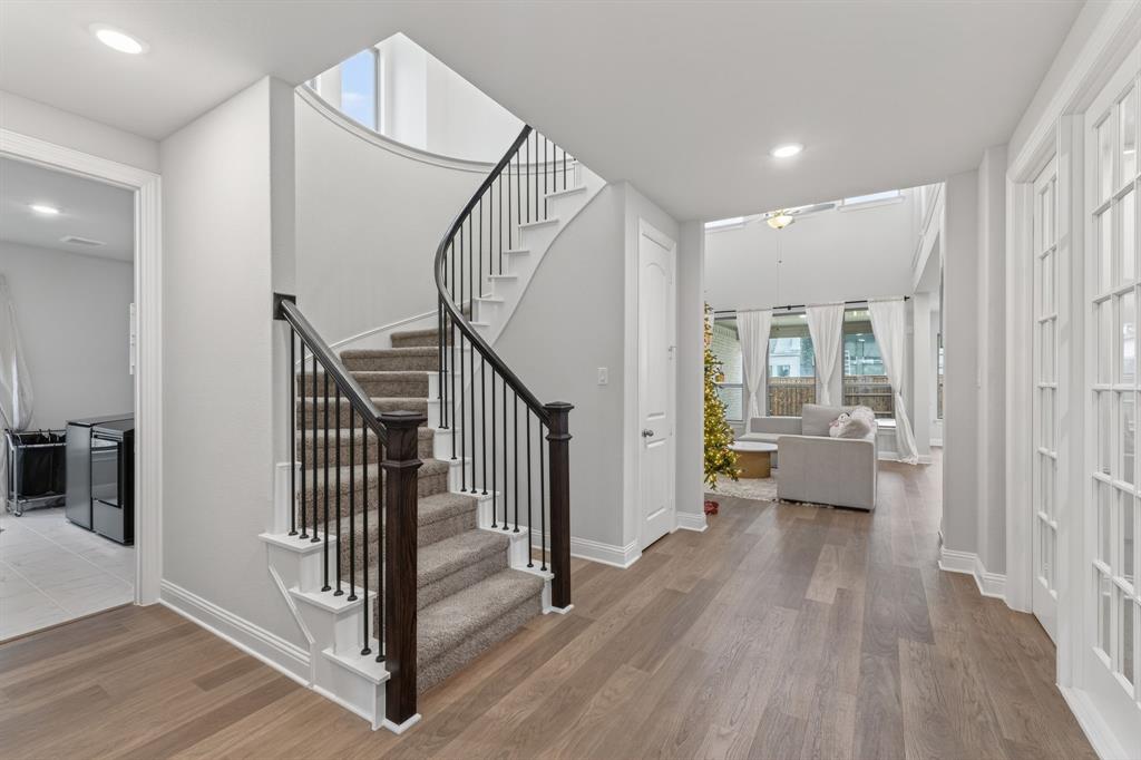 4150 Gambel Road Prosper, TX 75078 - Photo 3 of 39 Foyer entrance featuring light wood finished floors, stairway, recessed lighting, and washer / dryer