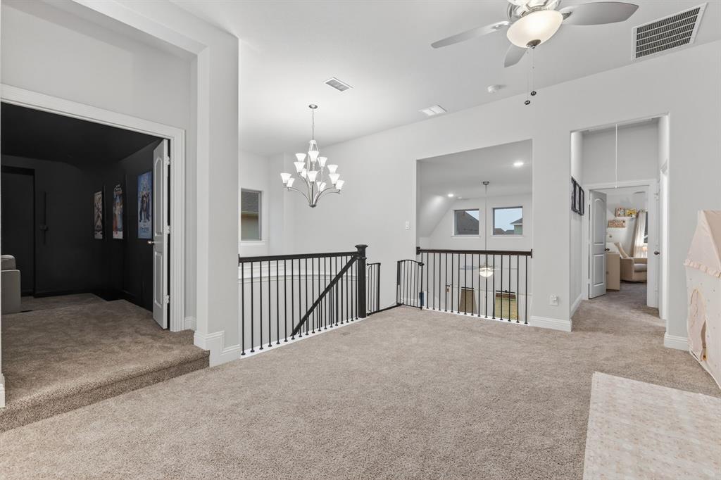 4150 Gambel Road Prosper, TX 75078 - Photo 30 of 39 Carpeted spare room with ceiling fan and a chandelier