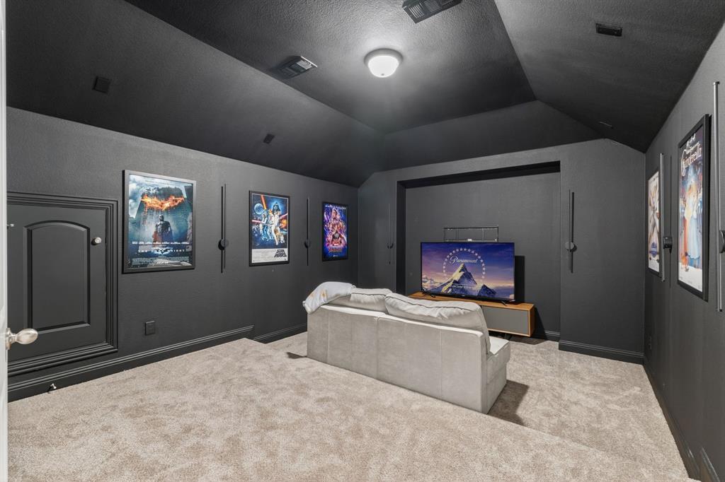 4150 Gambel Road Prosper, TX 75078 - Photo 31 of 39 Carpeted home theater room with vaulted ceiling