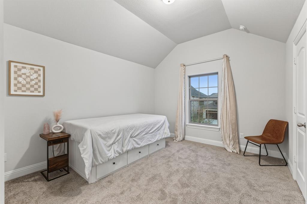 4150 Gambel Road Prosper, TX 75078 - Photo 32 of 39 Bedroom with light carpet and lofted ceiling