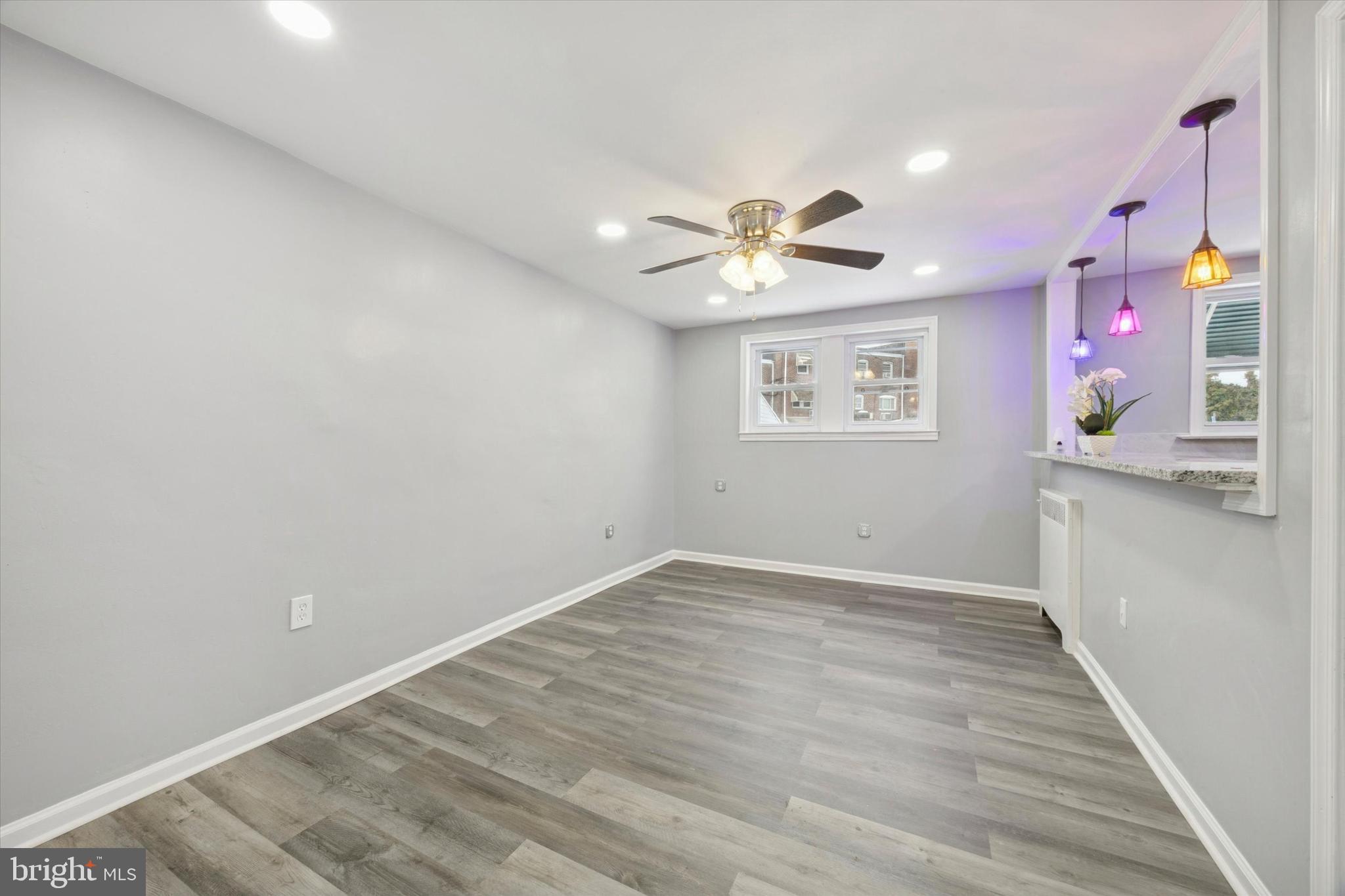 550 Wiltshire Road Upper Darby, PA 19082 - Photo 4 of 14 an empty room with a window and a chandelier fan