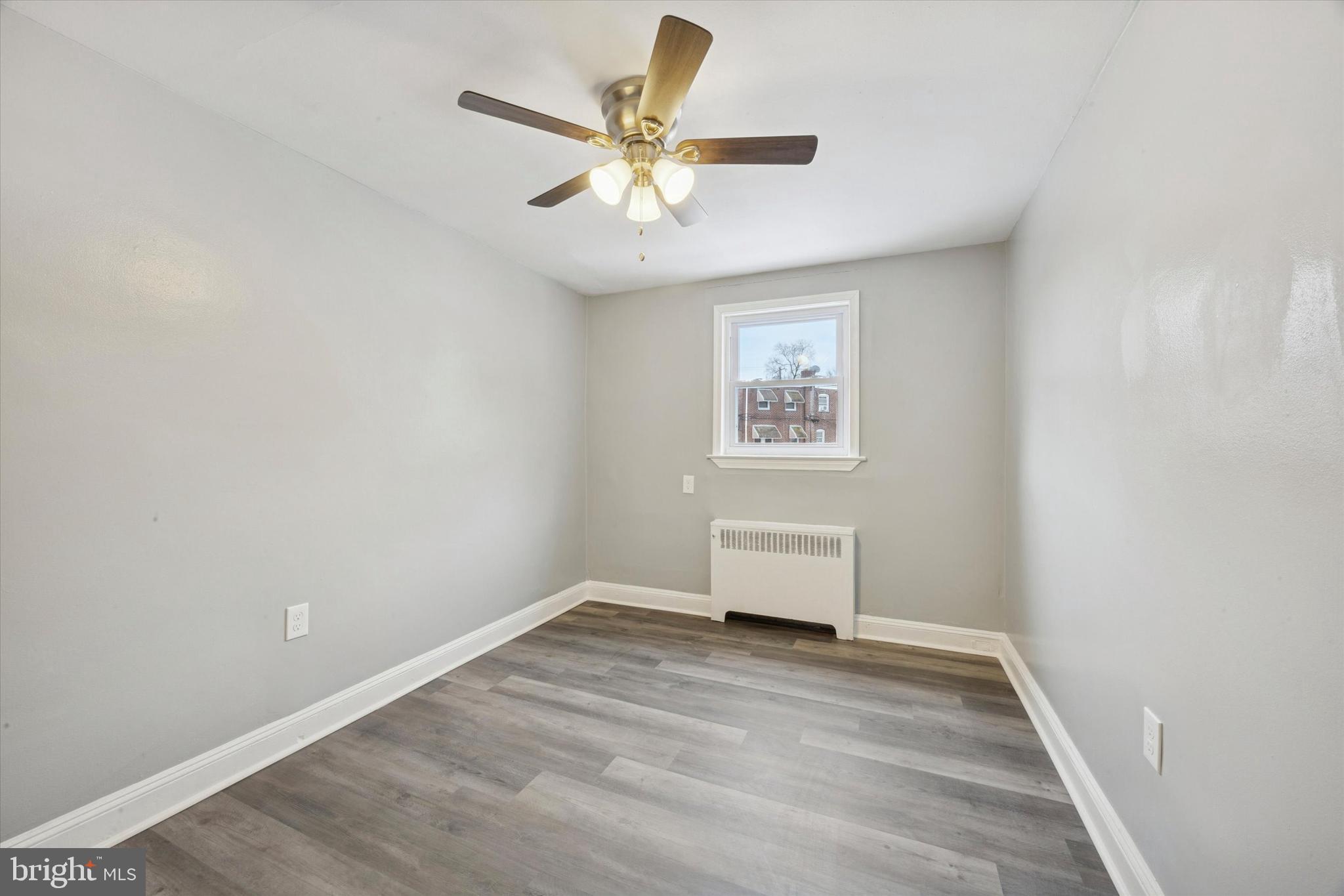 550 Wiltshire Road Upper Darby, PA 19082 - Photo 6 of 14 an empty room with a window and a ceiling fan