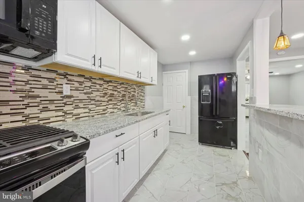 a kitchen with stainless steel appliances granite countertop a stove and a refrigerator