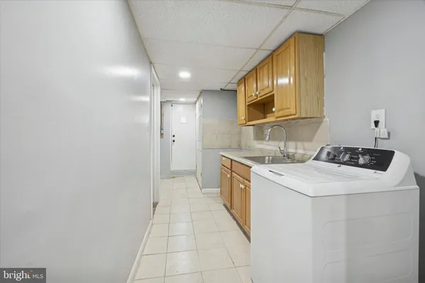 a kitchen with a sink cabinets and stainless steel appliances
