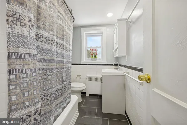 a bathroom with a sink a toilet and a shower