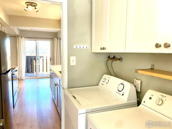 a kitchen with a sink cabinets and wooden floor