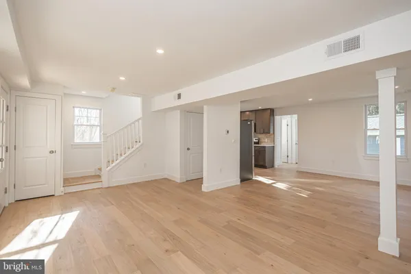 a view of empty room with wooden floor