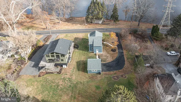 a view of a house with a yard and fence