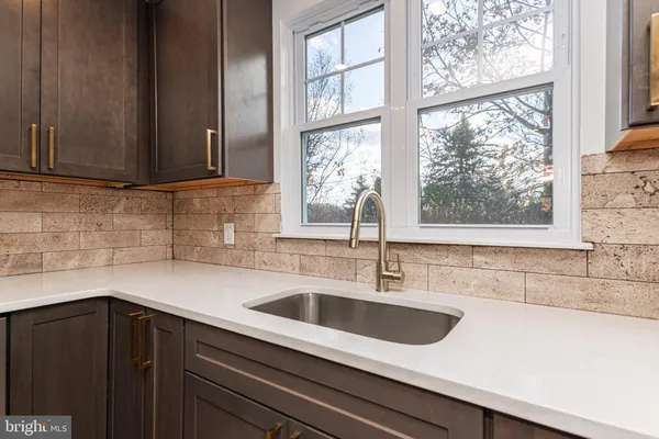 a kitchen with a sink and a window