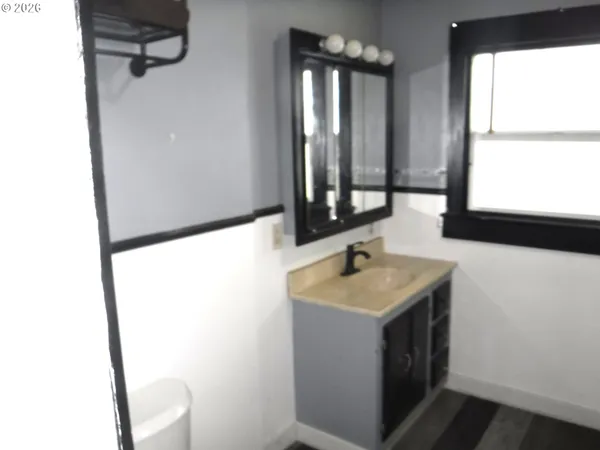 a bathroom with a sink and mirror with window