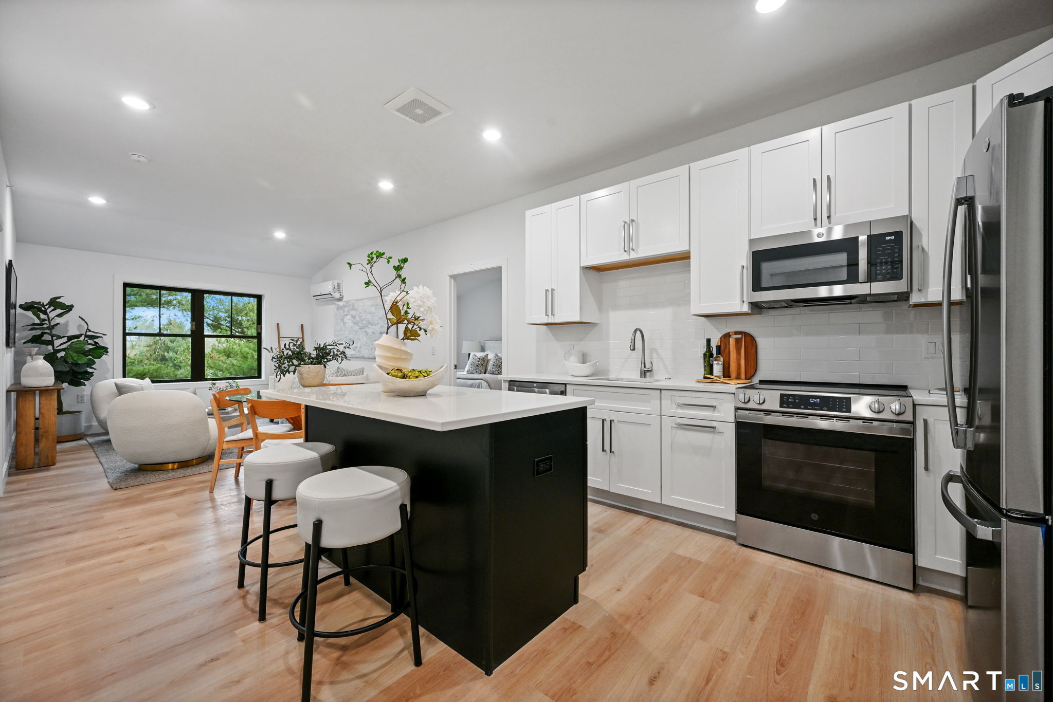 a kitchen with a sink appliances and cabinets