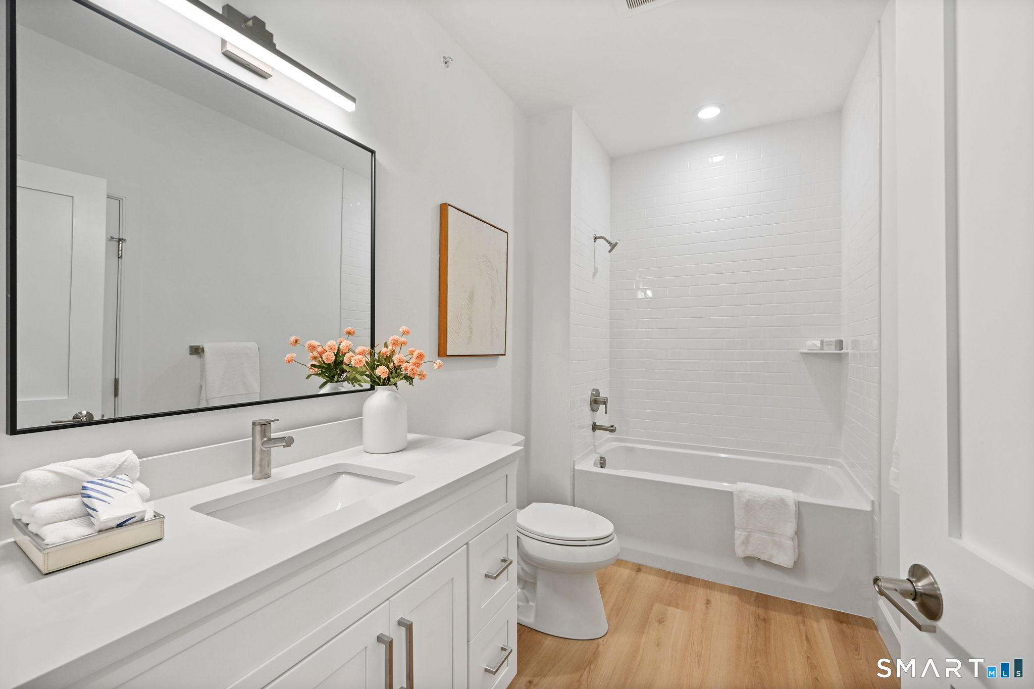 131 Beach Road, Unit 103 Fairfield, CT 06824 - Photo 14 of 28 a bathroom with a granite countertop sink toilet and shower