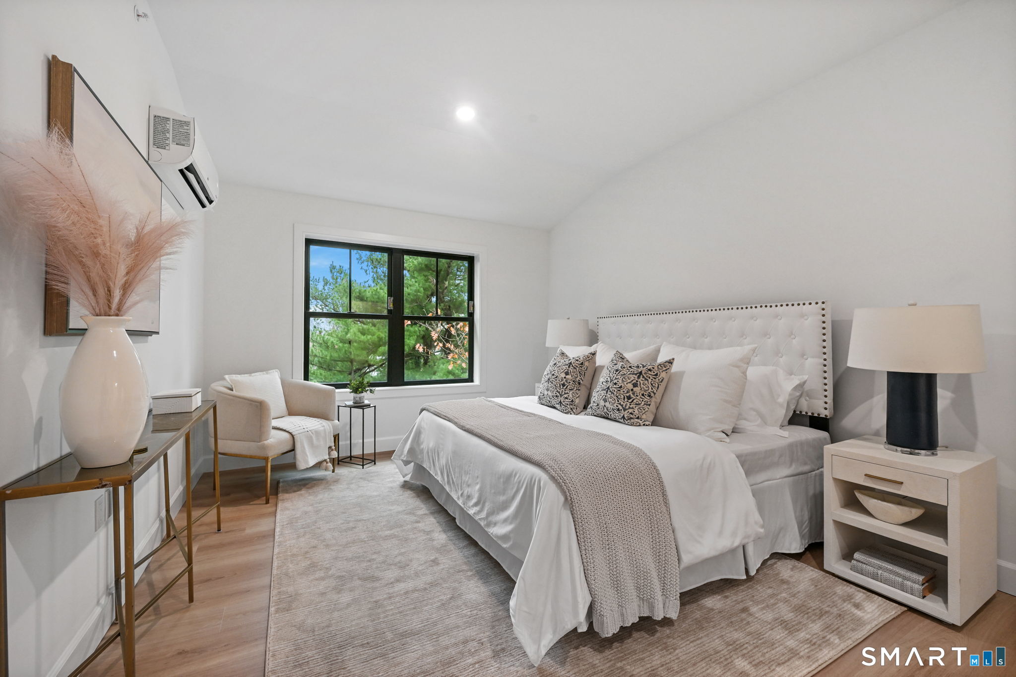 131 Beach Road, Unit 103 Fairfield, CT 06824 - Photo 16 of 28 a bedroom with a bed and a window