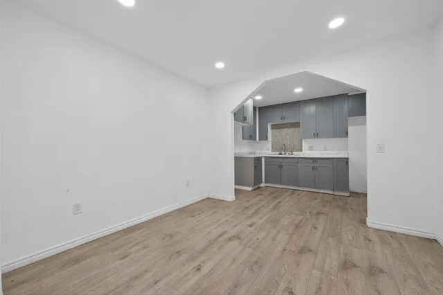 a view of wooden floor and windows in a room