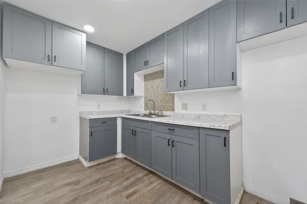 a kitchen with granite countertop cabinets sink and stainless steel appliances