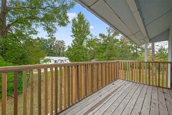 a balcony with wooden floor and outdoor space