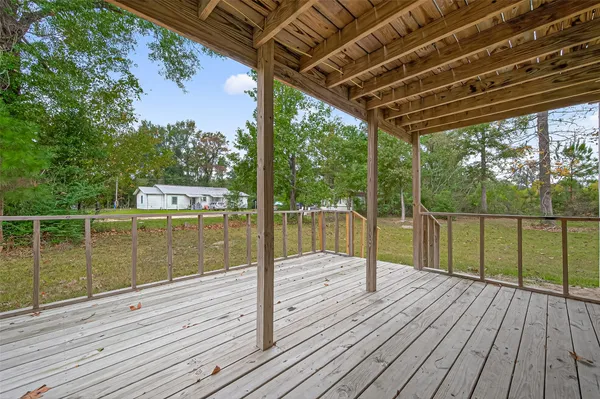 a view of a balcony with wooden floor