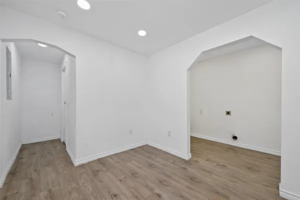 a view of an empty room with wooden floor