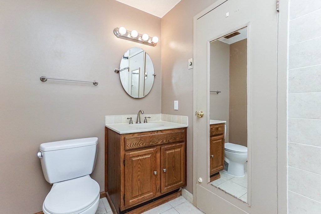 3 Summit Drive, Unit B2 Reading, MA 01867 - Photo 13 of 17 a bathroom with a toilet sink and mirror