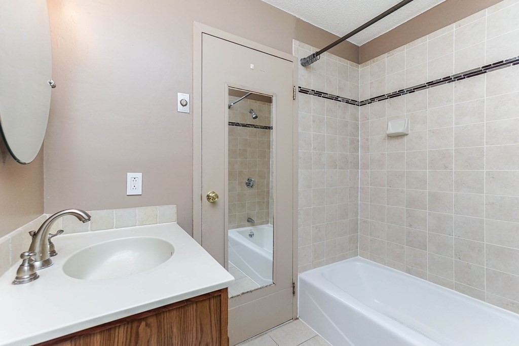 3 Summit Drive, Unit B2 Reading, MA 01867 - Photo 14 of 17 a bathroom with a sink and a bathtub