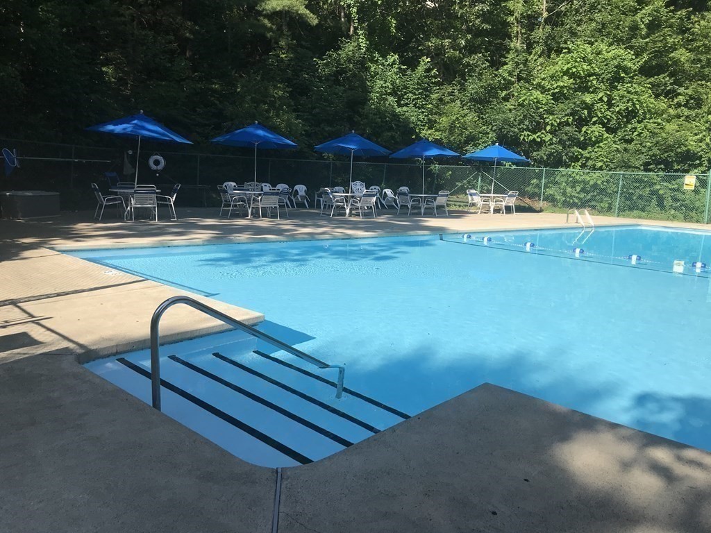 3 Summit Drive, Unit B2 Reading, MA 01867 - Photo 2 of 17 a view of swimming pool with outdoor seating