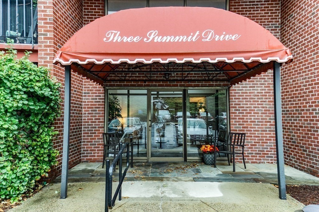 3 Summit Drive, Unit B2 Reading, MA 01867 - Photo 3 of 17 a view of a wooden door with a table and chairs
