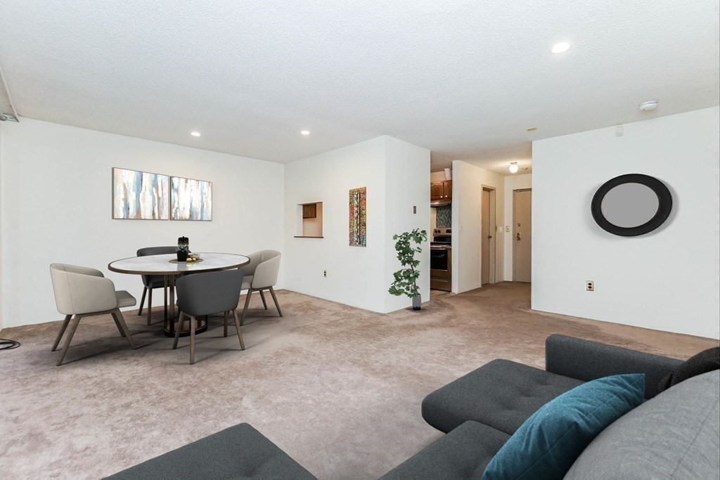 3 Summit Drive, Unit B2 Reading, MA 01867 - Photo 7 of 17 a living room with furniture a window and a dining table