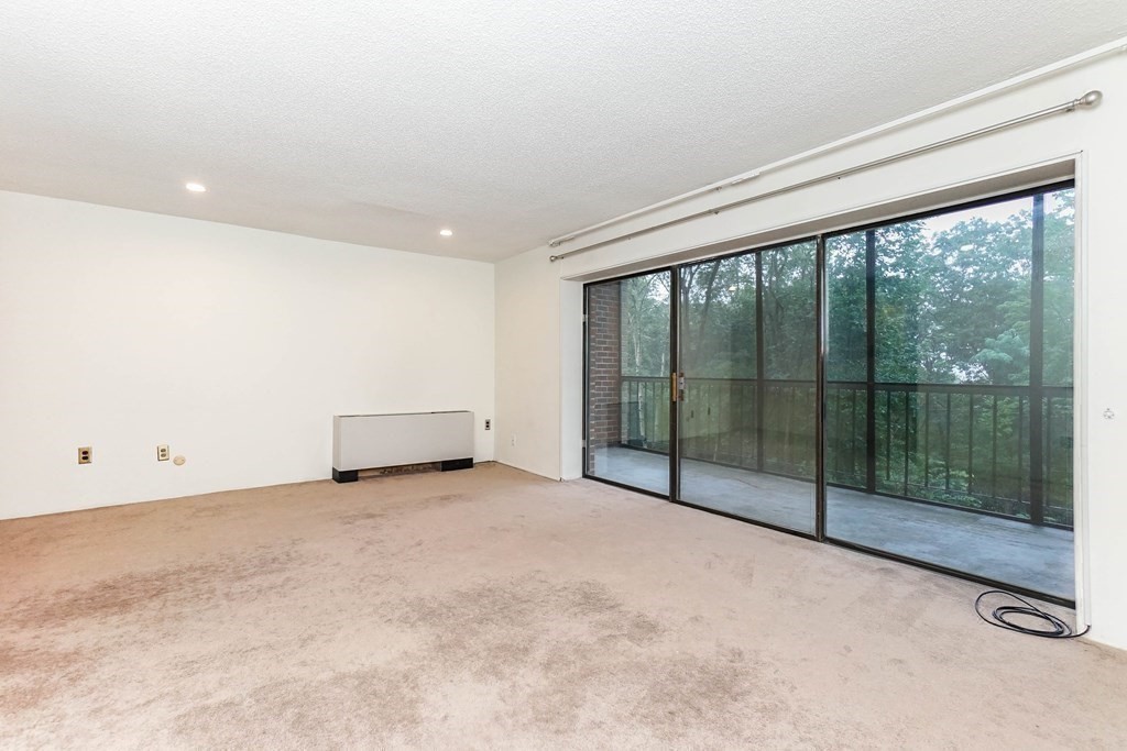 3 Summit Drive, Unit B2 Reading, MA 01867 - Photo 8 of 17 a view of an empty room with glass door