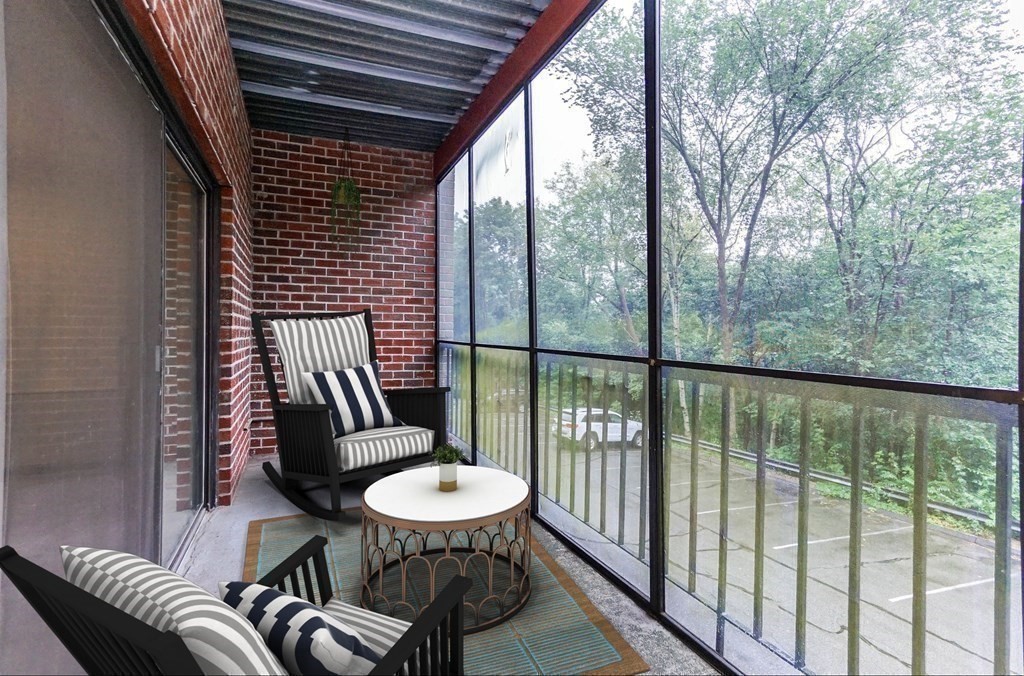3 Summit Drive, Unit B2 Reading, MA 01867 - Photo 9 of 17 a view of a balcony with a table and chairs