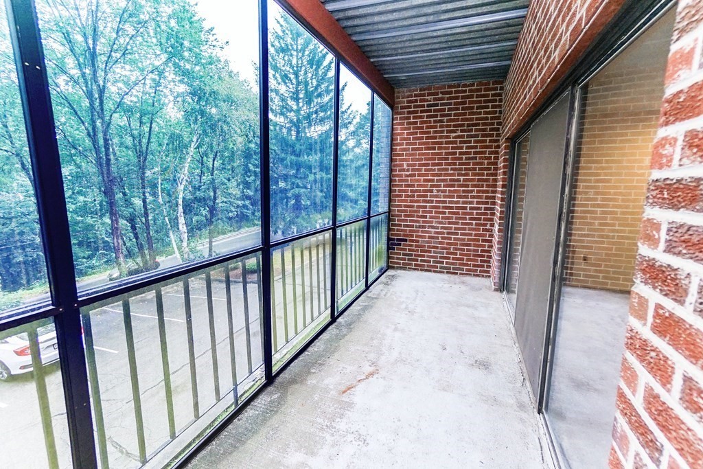 3 Summit Drive, Unit B2 Reading, MA 01867 - Photo 10 of 17 a view of a porch with wooden floor and stairs
