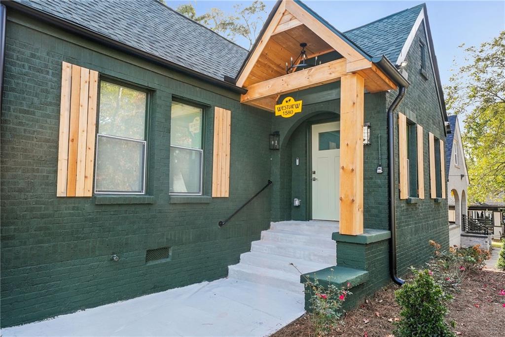 1580 Beecher Street Southwest Atlanta, GA 30310 - Photo 1 of 15 a front view of a house with a yard