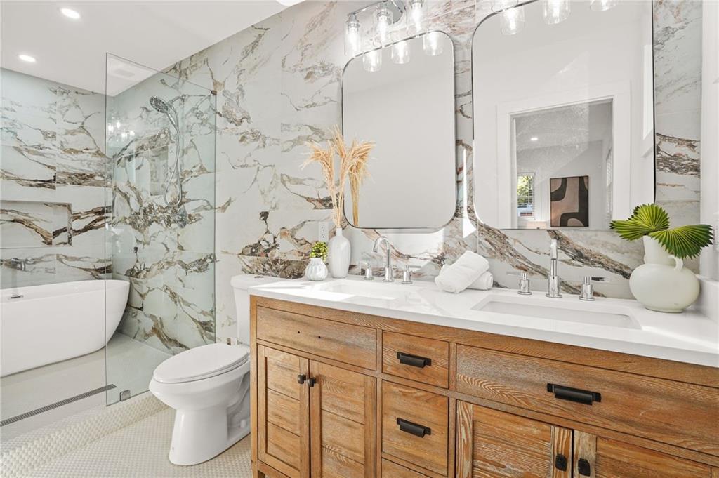1580 Beecher Street Southwest Atlanta, GA 30310 - Photo 13 of 15 a bathroom with a granite countertop toilet sink and mirror