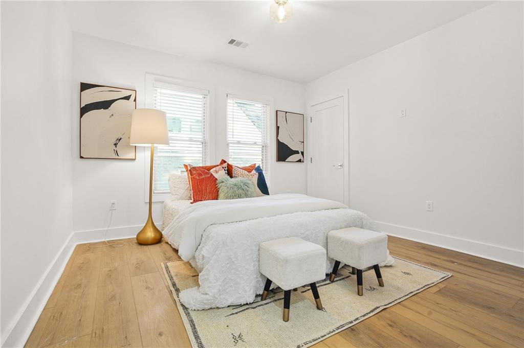 1580 Beecher Street Southwest Atlanta, GA 30310 - Photo 7 of 15 a bedroom with a bed and a table