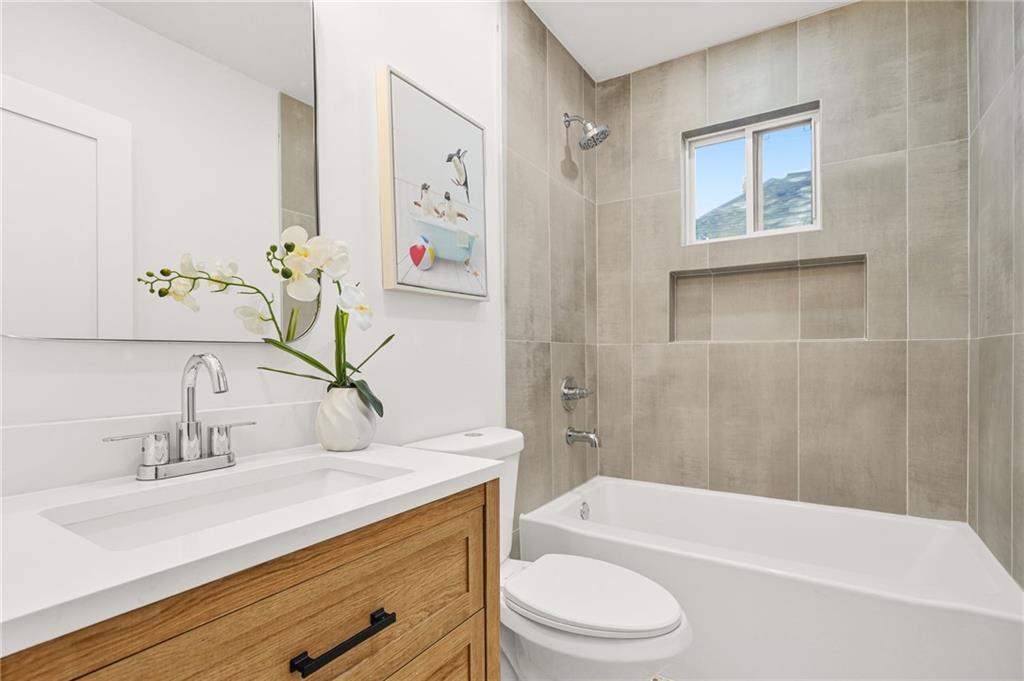 1580 Beecher Street Southwest Atlanta, GA 30310 - Photo 8 of 15 a bathroom with a granite countertop sink a toilet and bathtub