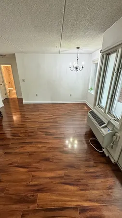 a view of a room with wooden floor