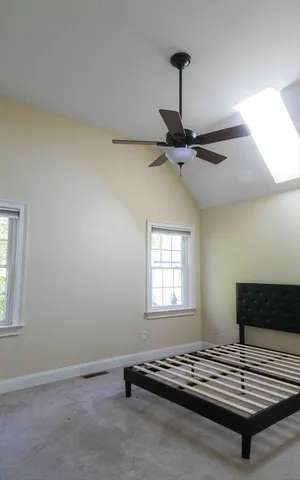 a view of a room with gym equipment on wooden floor
